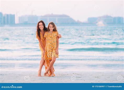 Beautiful Mother And Daughter At The Beach Enjoying Summer Vacation