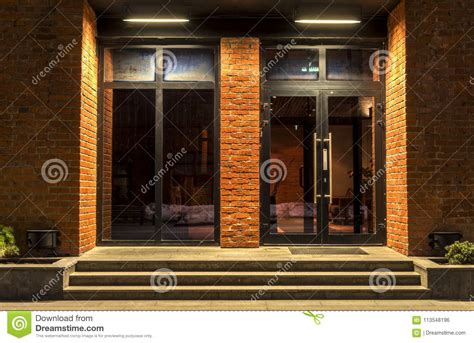 Two Glass Doors In A Brick Building In The Night Stock Photo Image Of
