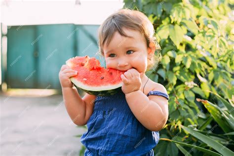 Premium Photo Charming Little Girl Eating Watermelon In The Yard On