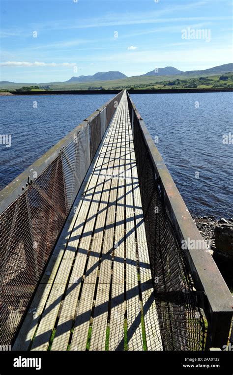 Llyn Trawsfynydd Lake Pedestrian Footbridge Stretching Into The Horizon