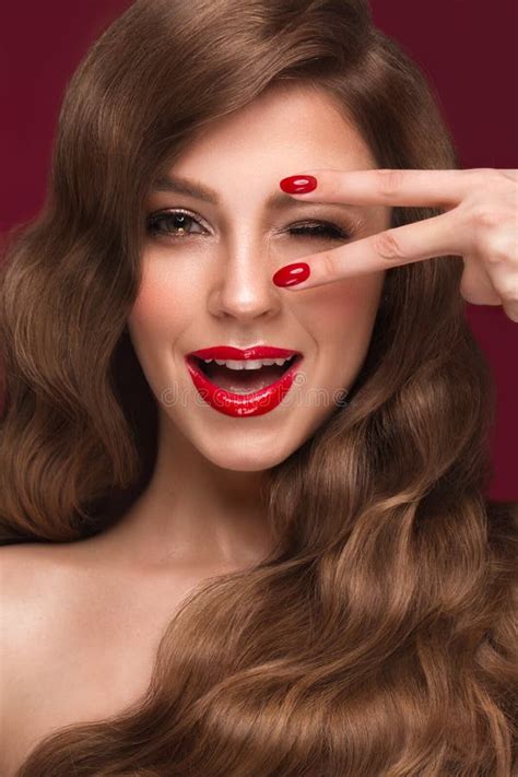 Beautiful Girl With A Classic Makeup Curls Hair And Red Nails Manicure Design Beauty Face