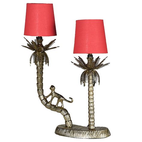 You get a monkey, holding an umbrella for a lamp. Brass Monkey Table Lamp | Coral Shades | Audenza
