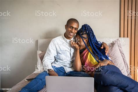 African American Nonbinary Person And Transgender Woman In Bed Watching