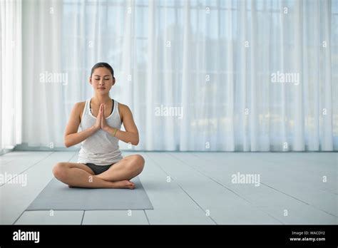 Focused Young Woman Meditating While Practicing Yoga Stock Photo Alamy