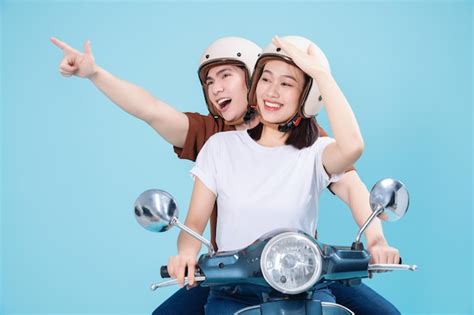 Premium Photo Young Asian Couple Ride Scooter On Background