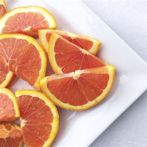 Sliced Oranges On A Chopping Board On A Wooden Table In The Kitchen