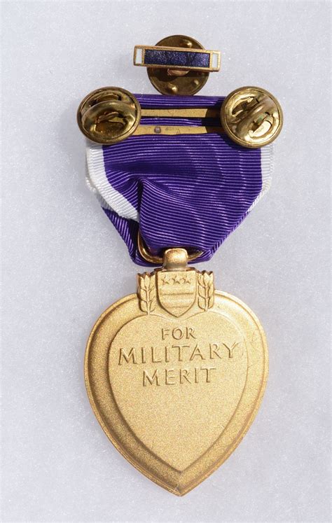 Backside View Of A Full Size Purple Heart Medal Which Is A United