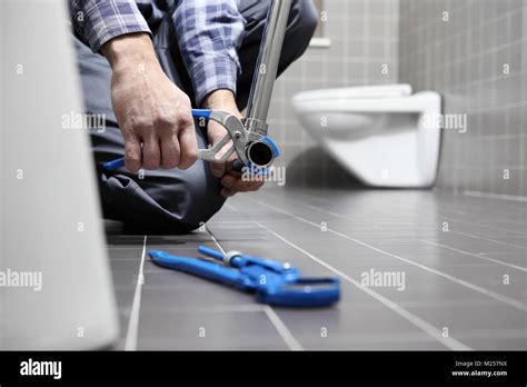 Hands Plumber At Work In A Bathroom Plumbing Repair Service Assemble And Install Concept Stock