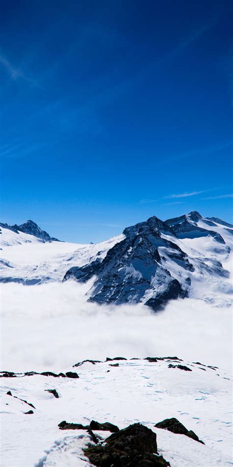 1080x2160 Mountains Snow Layer Clouds Glacier Landscape Wallpaper