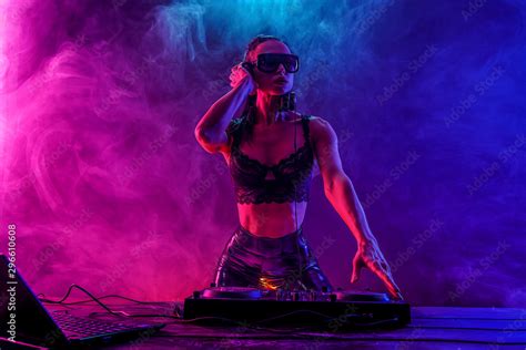 Young Sexy Woman Dj In Bra And Sunglasses Playing Music Headphones And