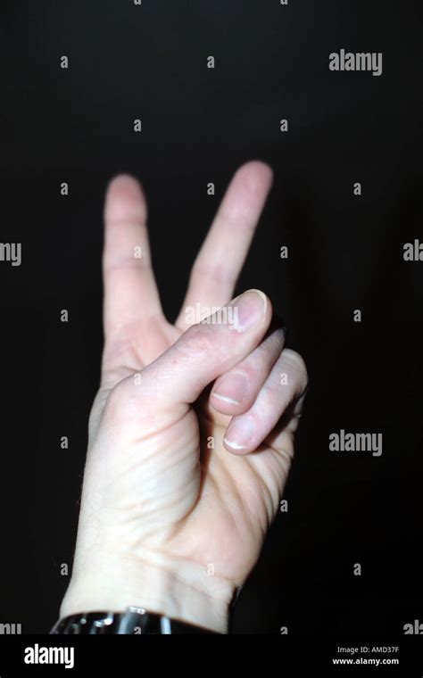 Man Holding Up Two Fingers Stock Photo Alamy