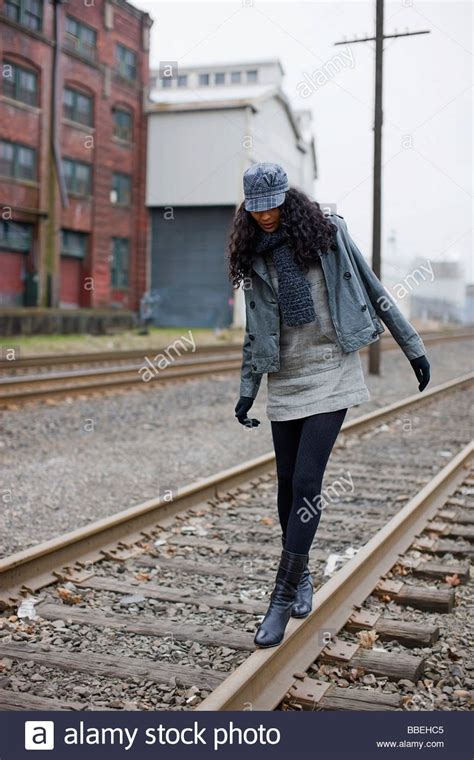 Woman Walking On Railroad Tracks In Urban Industrial Area Portland