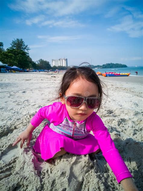 Little Asian Girl Playing On The Beach Vacation And Relaxing Concept