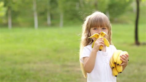 Girl Eating A Banana And Smiles Stock Video Footage 0008 Sbv 303492740 Storyblocks