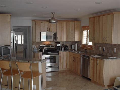 Granite is often used as a material for kitchen countertops. Natural birch kitchen with granite countertops | Kitchen ...