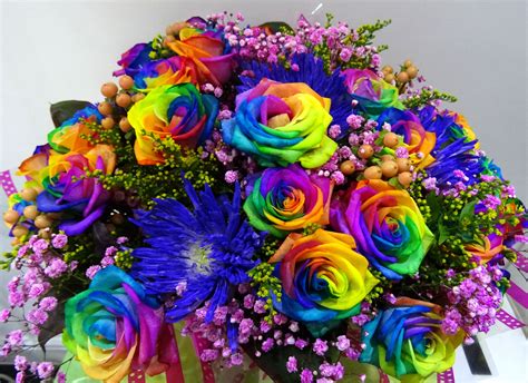 Rainbow Rose Mixed With Some Other Flowers In An Aqua Bouquet