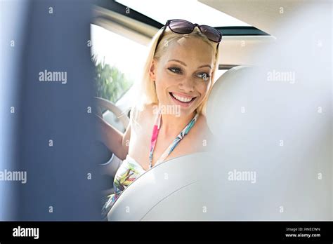Happy Beautiful Woman Looking Back While Driving Car Stock Photo Alamy