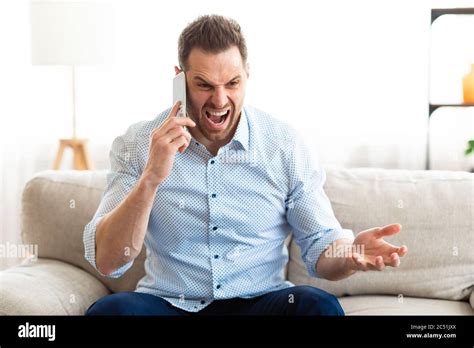 Angry Man Talking On Mobile Phone And Shouting Stock Photo Alamy