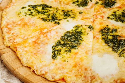 Photo Of Crunchy Pizza On Wooden Plate With Bottle Of Olive Oil Stock