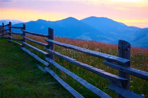 Sunset And Wooden Fence Along Pasture In The Ranch Nature Summer