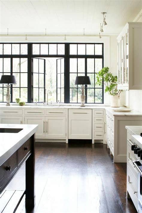 Black paint has been applied across the front and rear elevations, and all of the windows have been refitted with black window frames. 3 Reasons To Paint Window Trim Black - Emily A. Clark
