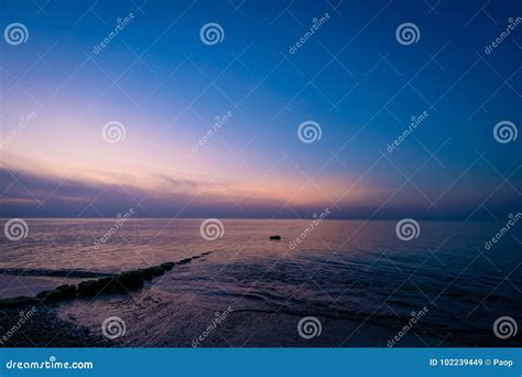 Wooden Wave Breakers On The Beach At Dusk Stock Image Image Of