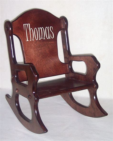 Putting your name on your seat. Wooden Kids Rocking Chair personalized cherry finish
