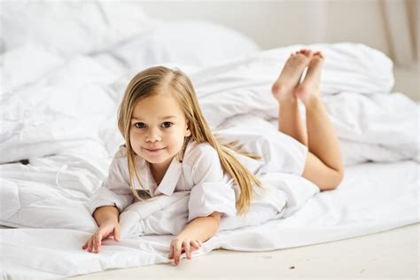 Premium Photo A Portrait Of Beautiful Little Girl In The Morning Bedroom