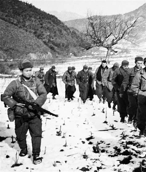 A Chinese Soldier Guarding Captured American Prisoners Dec 1950