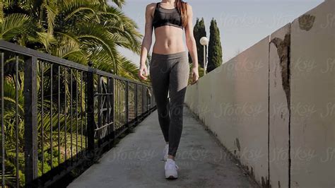 Anonymous Slim Sportswoman In Sportswear Walking By Stocksy Contributor Guille Faingold