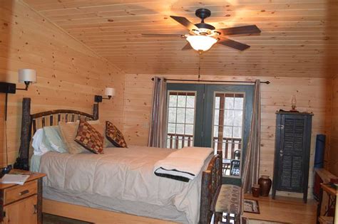 Log Cabin Bedroom With Queen Bed And Wooden Accents Cozy Cabins Llc