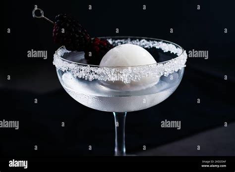 Full Moon Martini With Blackberry Garnish Side View Vodka Cocktail With An Opaque White Ice