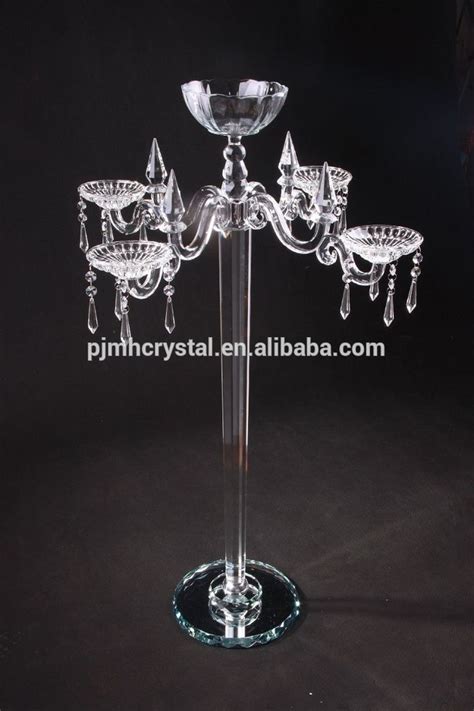 A Crystal Candle Holder With Four Candles On Its Base And Three Glass