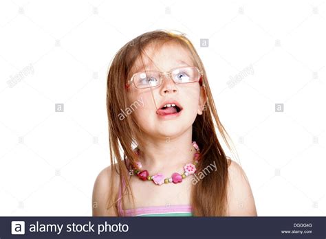 Little Girl In Eyeglasses Making Funny Face And Sticking
