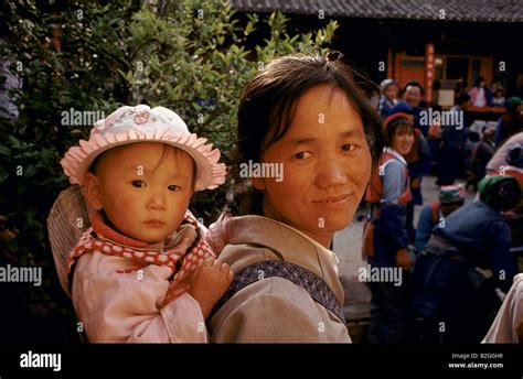 Mother Carrying Baby On Back China Stock Photo Alamy