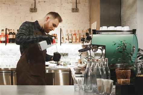 Focused Barista Pouring Milk In Coffee Cup To Make Latte Art Hand Of