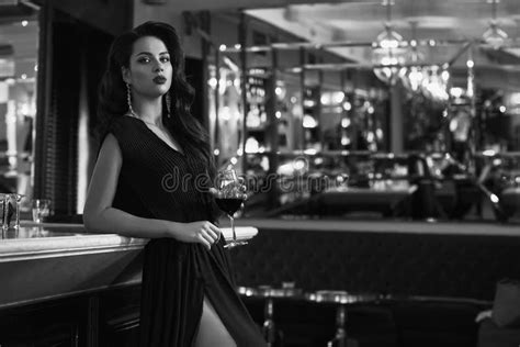Gorgeous Young Brunette Woman In Dark Dress With Wine Stock Photo