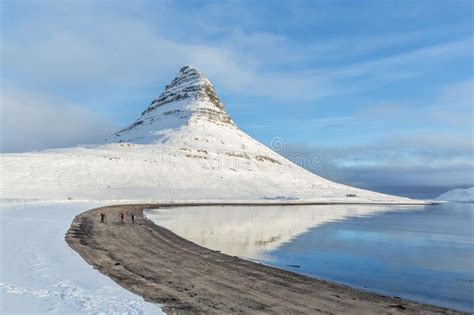 A Beautiful Stream And Kirkjufell Mountain Covered With Snow During