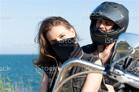 Closeup Portrait Of Beautiful Girl In Mask And Her Boyfriend In Helm