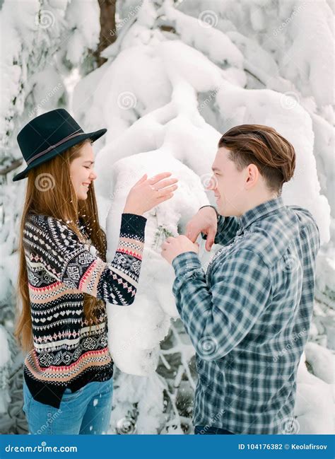 Guy And Woman In Winterwear Enjoying Snowfall Happy Moment Christmas Holiday Time Stock Photo