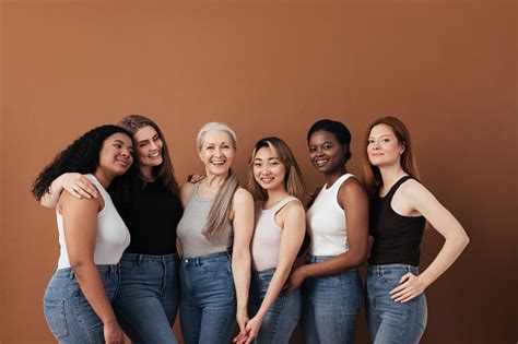 Multiethnic Group Of Women Of Different Ages Posing Against Brown