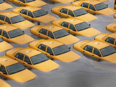 Taxi Cabs Sit In Floodwaters In A Parking Lot After Hurricane Sandy