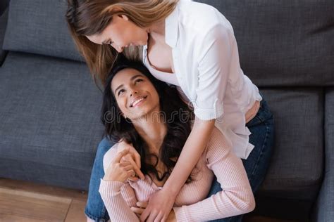 Cheerful Lesbians Hugging And Looking At Stock Image Image Of Home Homosexuality 216557225