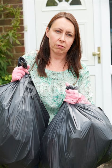 Woman Taking Out Garbage In Bags Stock Photo Royalty Free FreeImages