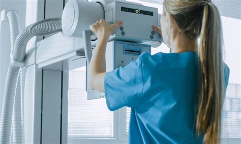 In The Hospital Female Technician Adjusts X Ray Scanner Machine