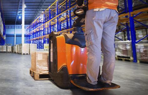 Workers Unloading Package Boxes On Pallets In Storage Warehouse Electric Forklift Pallet Jack