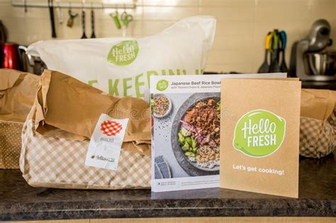Hello Fresh Meal Kits Packed In Paper Bags On A Kitchen Countertop