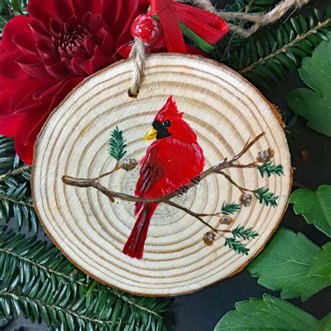A Wooden Ornament With A Cardinal On It