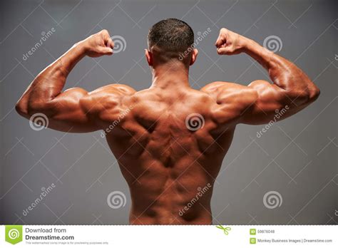 Male Bodybuilder Flexing His Biceps Back View Stock Photography