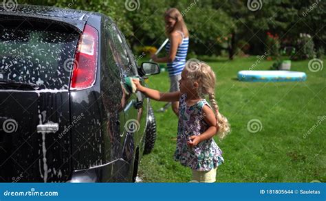 Mother And Little Daughter Washing Car Automobile With Broom And Sponge Stock Footage Video
